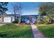 Charming single-story home with a well-manicured front yard and red door at 2261 W Briarwood Ave, Littleton, CO 80120