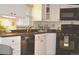 Well-maintained kitchen featuring white cabinets and updated appliances at 2261 W Briarwood Ave, Littleton, CO 80120