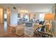 Open concept living room connected to dining area featuring hardwood floors and modern décor at 2261 W Briarwood Ave, Littleton, CO 80120
