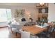 Open-concept living area with stylish furniture and a dining space for entertaining at 2261 W Briarwood Ave, Littleton, CO 80120