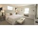 Serene bedroom with a plush bed, neutral decor, and a built-in shelving unit with a window at 2261 W Briarwood Ave, Littleton, CO 80120