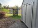 Backyard shed featuring a gray finish and double doors, with a gate leading to open greenery at 2261 W Briarwood Ave, Littleton, CO 80120