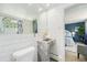 Modern bathroom featuring clean white tiling, marble sink, and a view into the main bedroom, offering a blend of style and functionality at 200 N Sherman St # 2, Denver, CO 80203