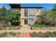 Charming two-story building with brick and gray exterior with manicured landscaping and brick walkway leading to the entrance at 200 N Sherman St # 2, Denver, CO 80203