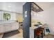 Modern kitchen with stainless steel appliances, white cabinets, breakfast bar and seamless integration with the adjacent living spaces at 200 N Sherman St # 2, Denver, CO 80203