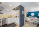 Stylish kitchen showcasing sleek countertops, white cabinetry, stainless steel appliances, and seamless flow into the living area at 200 N Sherman St # 2, Denver, CO 80203