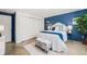 Comfortable bedroom featuring blue accent wall, closet space, and stylish decor with a cozy rug to add warmth at 200 N Sherman St # 2, Denver, CO 80203