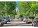 View of tree-lined street with parked cars, leading to a view of the Colorado State Capital building in the distance at 200 N Sherman St # 2, Denver, CO 80203