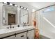 Stylish bathroom with double sinks, barn door vanity, and whimsical mushroom-themed shower curtain at 7453 S Norfolk St, Aurora, CO 80016