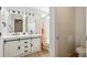 Stylish bathroom featuring a modern double sink vanity with barn doors and mushroom shower curtain at 7453 S Norfolk St, Aurora, CO 80016