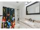 Stylish bathroom featuring modern vanity, mushroom-themed shower curtain, and granite countertop at 7453 S Norfolk St, Aurora, CO 80016