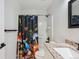 Stylish bathroom featuring modern vanity, mushroom-themed shower curtain, and granite countertop at 7453 S Norfolk St, Aurora, CO 80016