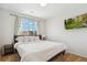 Bright bedroom featuring a large window with backyard views and a wall-mounted television at 7453 S Norfolk St, Aurora, CO 80016