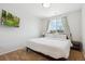 Cozy bedroom with a large window for natural light, and a wall-mounted television at 7453 S Norfolk St, Aurora, CO 80016