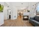 Bright living room with open floor plan, wood floors, fireplace, and connection to the updated kitchen at 7453 S Norfolk St, Aurora, CO 80016