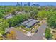 A high-angle aerial view showcases the property's proximity to lush greenery and the distant city skyline at 2955 N Gilpin St, Denver, CO 80205