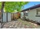 Cozy backyard featuring a small patio, storage shed, privacy fence, and mature landscaping at 2955 N Gilpin St, Denver, CO 80205