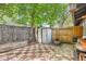 Private backyard featuring a shed, trees, patio, and a wooden fence at 2955 N Gilpin St, Denver, CO 80205