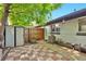 Cozy backyard patio featuring red and white checkered pavers, a storage shed, and a charming wooden bench at 2955 N Gilpin St, Denver, CO 80205
