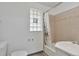 Bathroom showcasing a bathtub with shower, tiled walls, vanity sink, and window at 2955 N Gilpin St, Denver, CO 80205