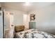 Cozy bedroom with neutral walls, wood floors, and a view into the bathroom at 2955 N Gilpin St, Denver, CO 80205
