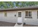 Charming home exterior featuring a white door and a well-maintained gray brick wall at 2955 N Gilpin St, Denver, CO 80205