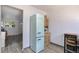 Kitchen area featuring a retro style refrigerator, wood cabinet, and adjacent view of the living area at 2955 N Gilpin St, Denver, CO 80205