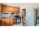 Charming kitchen featuring wood cabinets, stainless steel appliances, and a vintage-style refrigerator at 2955 N Gilpin St, Denver, CO 80205