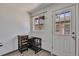 Bright kitchen area with wood-style floors, a serving cart, and a white door leading to the exterior at 2955 N Gilpin St, Denver, CO 80205