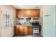 Stylish kitchen with wood cabinets, stainless steel oven, and an eye-catching backsplash design at 2955 N Gilpin St, Denver, CO 80205