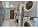 Convenient laundry room with stacked washer and dryer units, plus a door to the outside at 2955 N Gilpin St, Denver, CO 80205