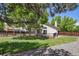 Enjoy outdoor living in this backyard featuring a wood deck, mature trees, and a well-maintained lawn at 9564 Cordova Dr, Highlands Ranch, CO 80130