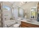 Bright bathroom with a shower-tub combo, granite vanity, and large mirror at 9564 Cordova Dr, Highlands Ranch, CO 80130