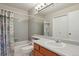 Well-maintained bathroom featuring a shower-tub combo, gray tile, and functional vanity at 9564 Cordova Dr, Highlands Ranch, CO 80130