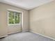 Bright, vacant bedroom with soft gray carpeting and natural light from a large window at 9564 Cordova Dr, Highlands Ranch, CO 80130