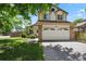 Charming two-story home with a manicured front yard, and a two car garage, showing great curb appeal at 9564 Cordova Dr, Highlands Ranch, CO 80130