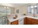 Cozy kitchen featuring white countertops, wooden cabinets, stainless steel appliances, and view into breakfast nook at 9564 Cordova Dr, Highlands Ranch, CO 80130