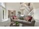 Cozy living room features modern decor and an open layout with staircase and dining area at 9564 Cordova Dr, Highlands Ranch, CO 80130