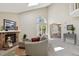 Inviting living area with brick fireplace and access to dining room and backyard patio at 9564 Cordova Dr, Highlands Ranch, CO 80130