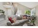 Comfortable living area with stylish decor, open staircase, and large window with natural light at 9564 Cordova Dr, Highlands Ranch, CO 80130