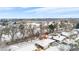 An aerial view of a snow-covered neighborhood with a park, trees, and residential homes at 2842 S Newport St, Denver, CO 80224