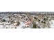 An aerial view of a snow-covered neighborhood with views of the city skyline in the distance at 2842 S Newport St, Denver, CO 80224