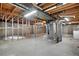 Unfinished basement with exposed ceiling, concrete flooring, and framed walls at 2842 S Newport St, Denver, CO 80224