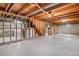 Unfinished basement with concrete floor, framed walls, and utility connections at 2842 S Newport St, Denver, CO 80224