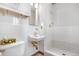 Bathroom with a unique basin sink, tiled shower, and storage at 2842 S Newport St, Denver, CO 80224