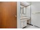 Half bath featuring vintage style basin, ample counter space, and vanity storage at 2842 S Newport St, Denver, CO 80224