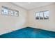 Bedroom with bright natural light from its large windows and blue carpeting at 2842 S Newport St, Denver, CO 80224