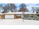 Ranch-style home with a brick and siding exterior, two-car garage, and a snow-covered lawn at 2842 S Newport St, Denver, CO 80224