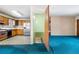 View of the kitchen with wood cabinets, stainless steel refrigerator, and unique flooring at 2842 S Newport St, Denver, CO 80224