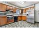 Functional kitchen features classic appliances, ample cabinet space, and patterned flooring at 2842 S Newport St, Denver, CO 80224